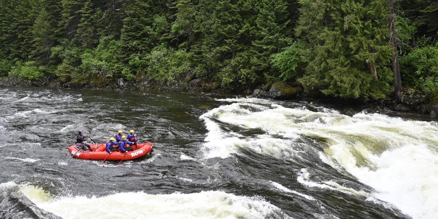 A red raft entering the tongue of a whitewater rapid on the Lochsa river